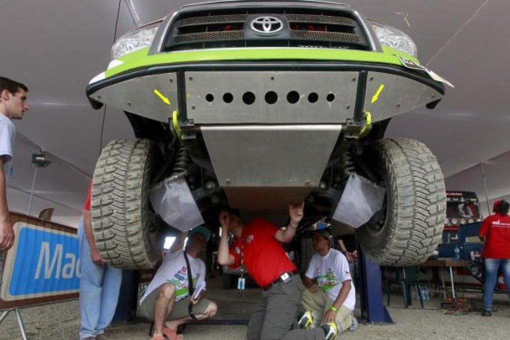 A scrutineer makes final checks on a vehicle. Photo: Reuters