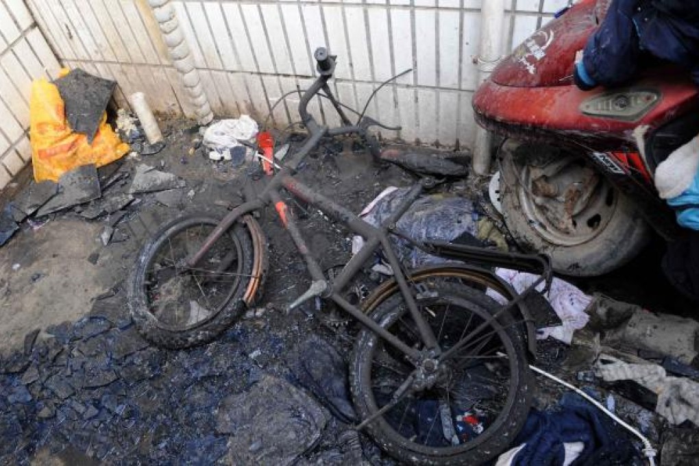 A damaged bicycle at the scene of the fire. Photo: Xinhua