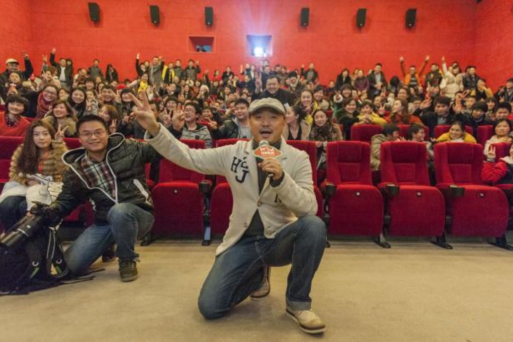 Director and actor Xu Zheng (centre) speaks with fans at a movie theatre in Chongqing to promote his latest film "Lost in Thailand". Photo: AP