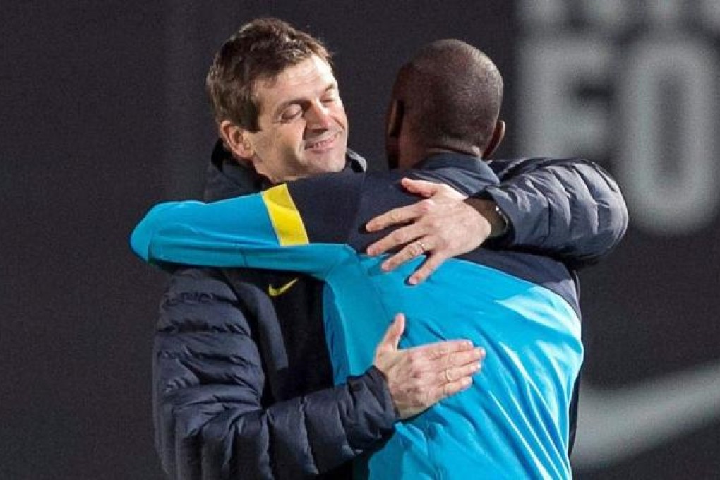 Tito Vilanova is welcomed back to training by fellow cancer sufferer Eric Abidal. Photo: EPA
