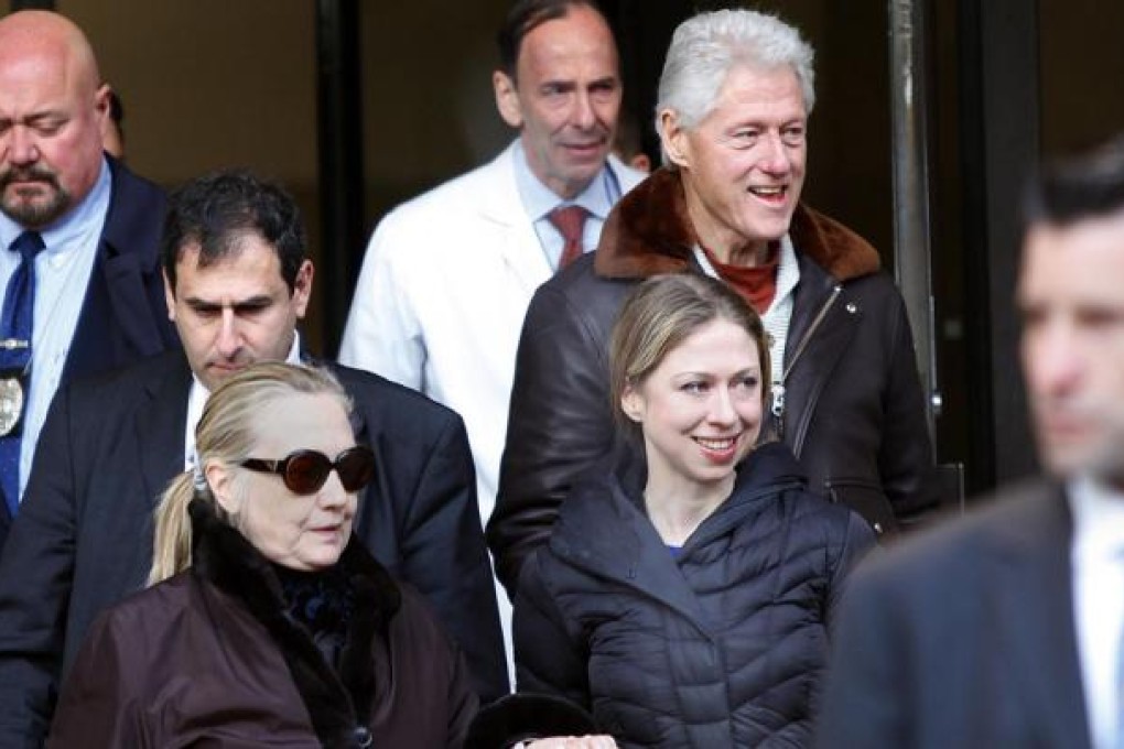 Hillary Clinton leaves a New York hospital with Bill Clinton and daughter Chelsea. Photo: Reuters