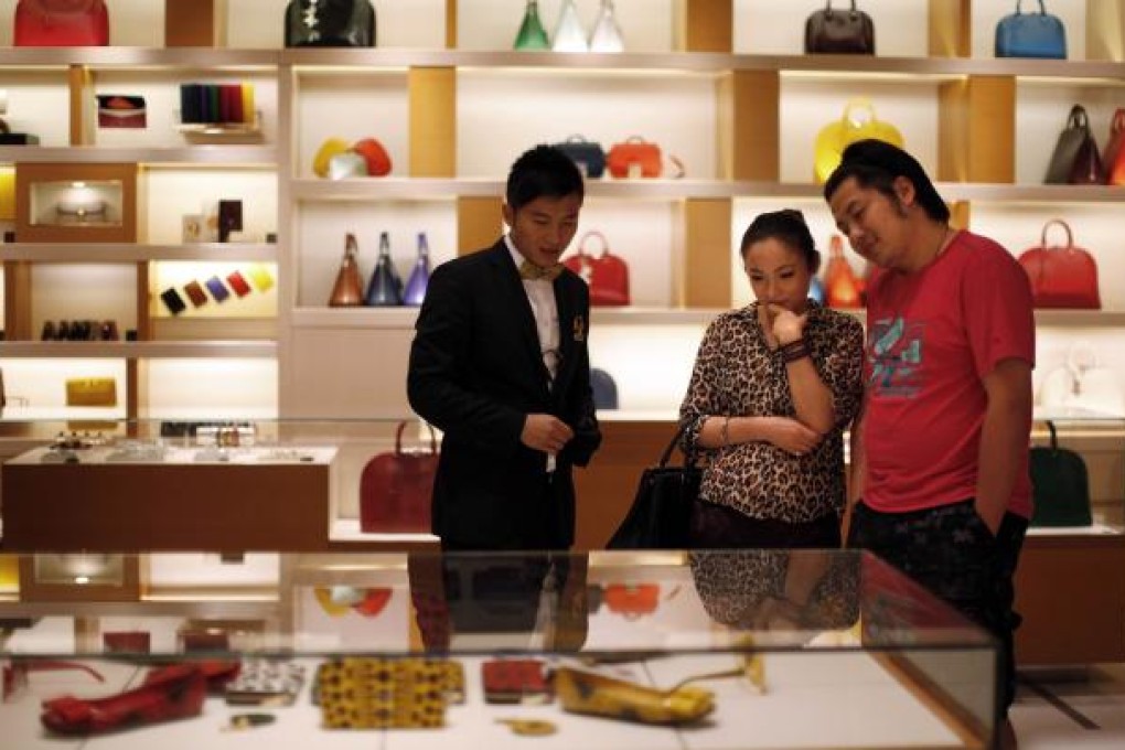A couple shop at a Louis Vuitton store in downtown Shanghai. Photo: Reuters