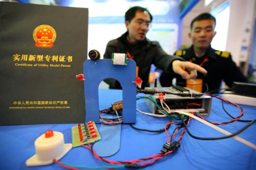Participants show the burglar alarm and GPS facility for vehicles during an exhibition on science, technology and innovation projects in Nanjing. Photo: Xinhua