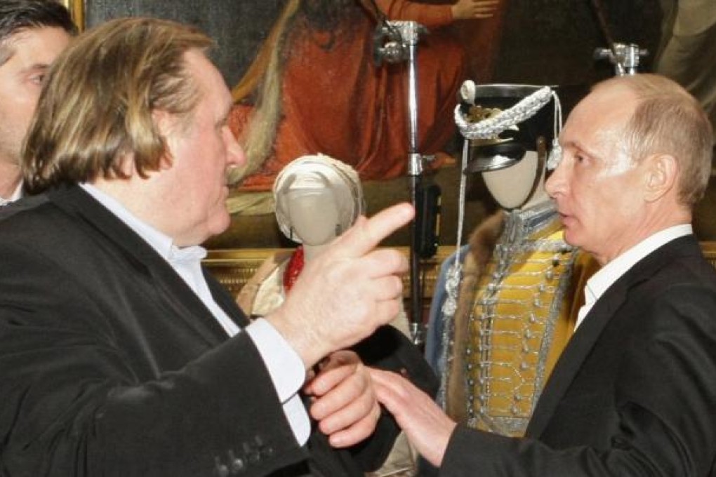 French actor Gerard Depardieu (left) speaks with Vladimir Putin during a meeting in St. Petersburg in 2010. Photo: Reuters