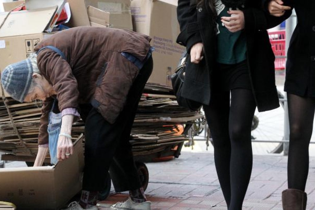 An old woman collects cardboard for cash in Causeway Bay. Photo: K.Y. Cheng