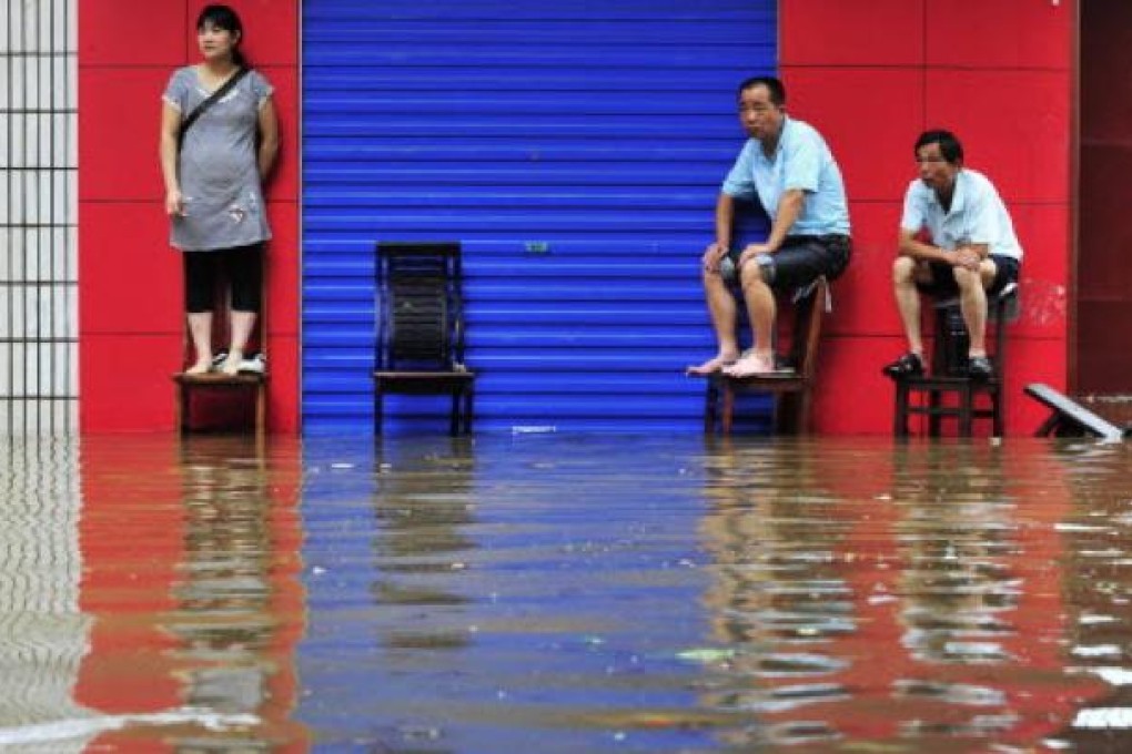 Residents of Changsha, Hunan province, endure flooding in June 2011. This year, 673 people have already died in floods in China. Photo: Reuters