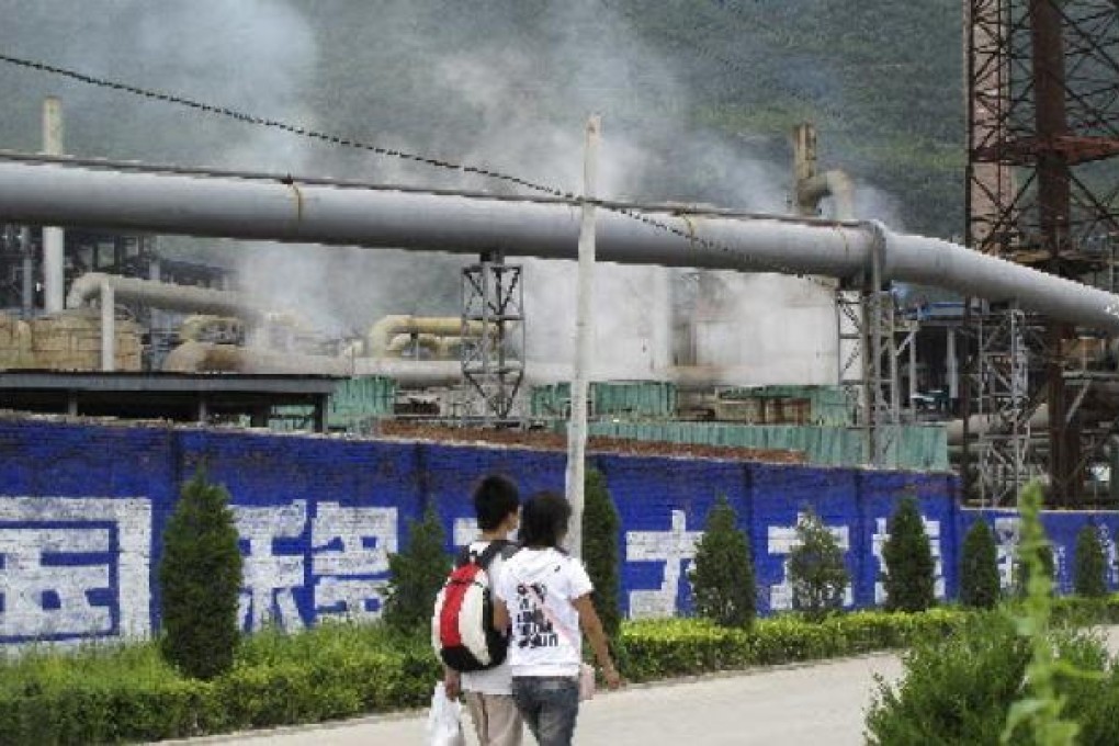 Residents walk past a zinc smelter belonging to the Dongling Group, in Fengxian county, Shaanxi province. Photo: Reuters