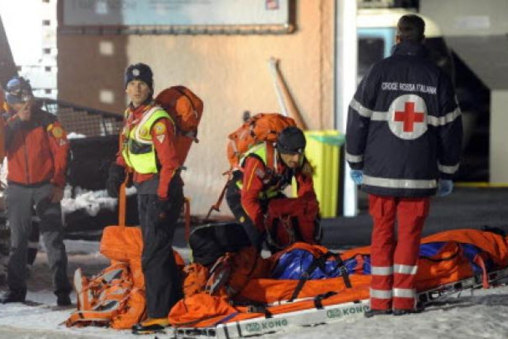 Rescuers of Italian Alpine Relief at Mount Cermis, where six Russian tourists died in an accident with snowmobiles at Cavalese at Trento. Photo: EPA