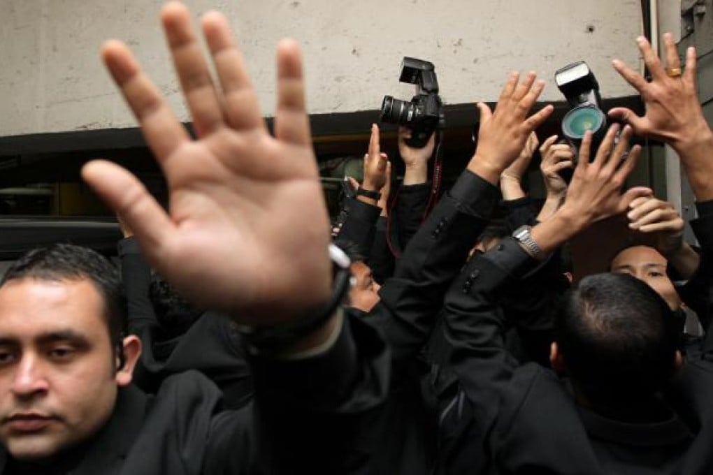 The media surrounds Steven Lo as he leaves court yesterday. He and Joseph Lau are accused of offering a HK$20 million bribe to secure a land deal. Photo: Dickson Lee