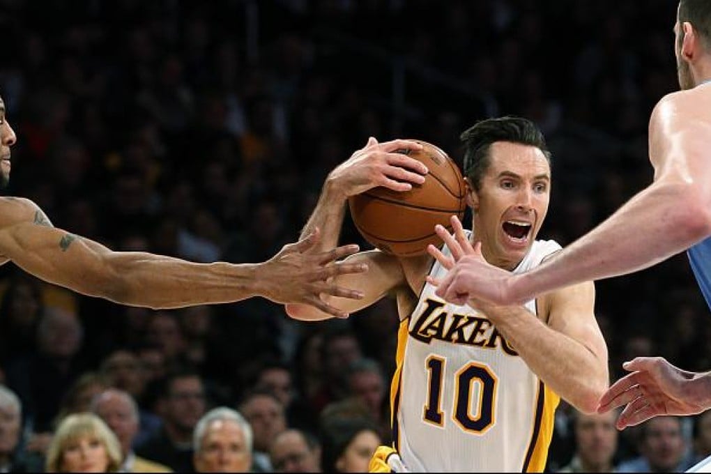 The Lakers' Steve Nash is double-teamed by the Nuggets.