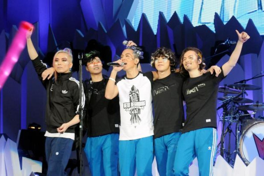 Quincy Tam, Alan Po, Desmond Tam, Tom To and Ronny Lay from local rock band Mr. take to the stage.