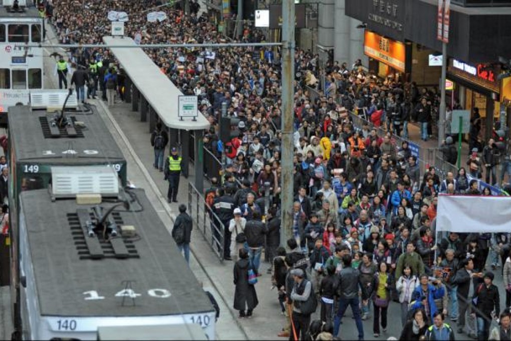 Thousands of pro-democracy protesters take to the streets calling for new Hong Kong Chief Executive Leung Chun-ying to step down in Hong Kong. Photo: AFP