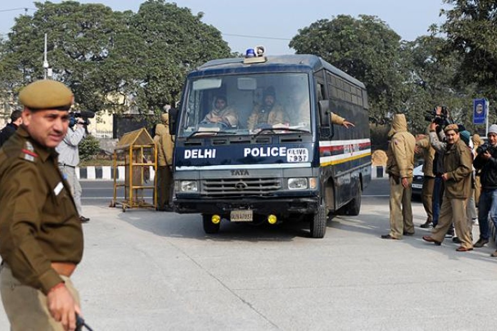Indian police personnel guide a vehicle, which is believed to be carrying the accused in a gang-rape and murder case, at an entrance to Saket District Court in New Delhi on Monday. Photo: AFP