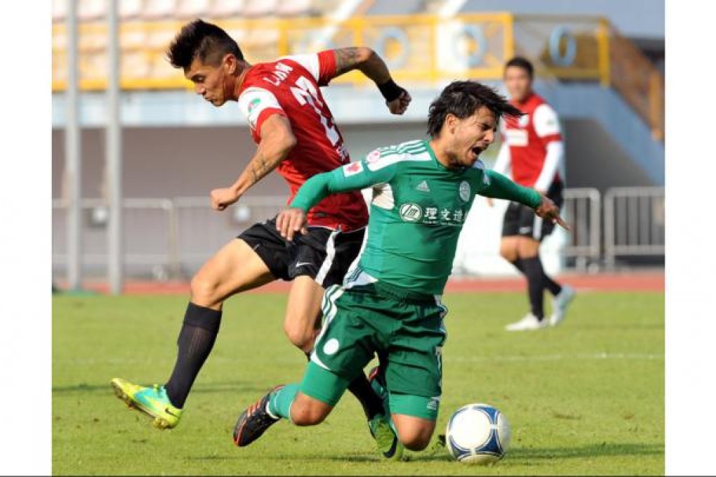 Tai Po's Aender Mesquita is tackled by Landon Ling. Photo: Xinhua