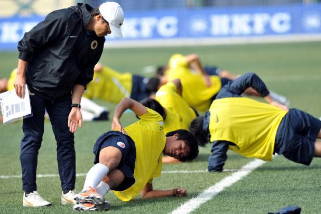 Hong Kong coach Kim Pan-gon puts his players - at least those that turned up - through their paces at Football Club. Photo: Xinhua