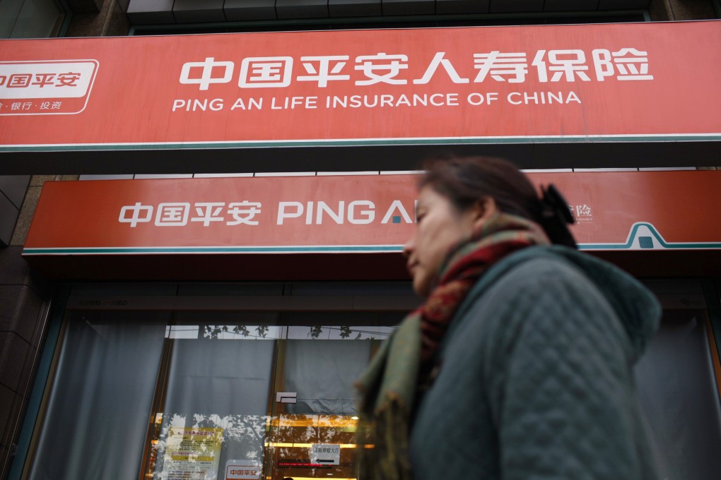A woman walks past a Ping An Insurance building in Shanghai December 6, 2012. Photo: Reuters