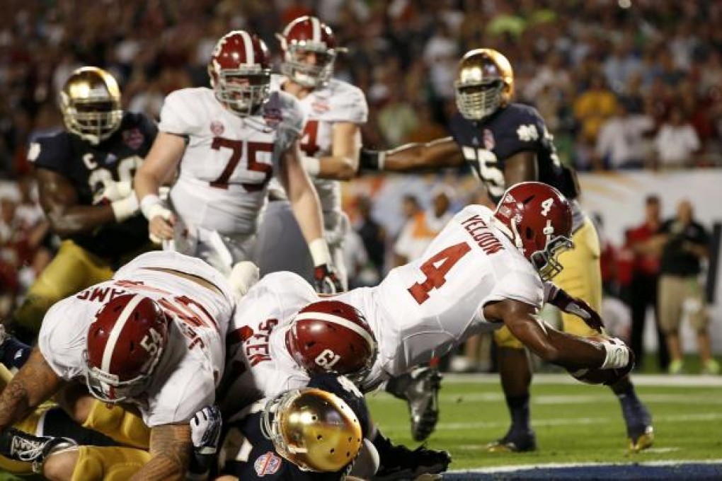 Alabama running back T.J. Yeldon scores against Notre Dame in their NCAA national championship game. Photo: Reuters