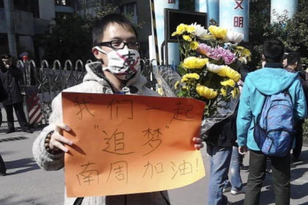 Aman wearing a mask with words "Silent" holds a banner reading: "Let's chase our dreams together." Photo: AP