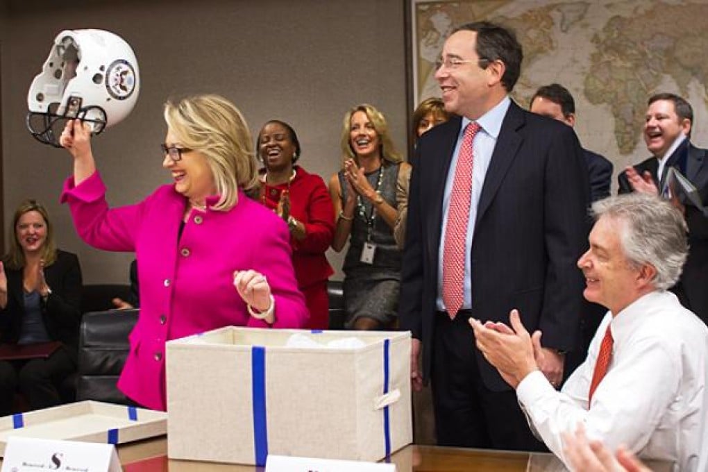 US Secretary of State Hillary Clinton receives a helmet after chairing a meeting of the State Departments leadership team on her first day back to work. Photo: EPA