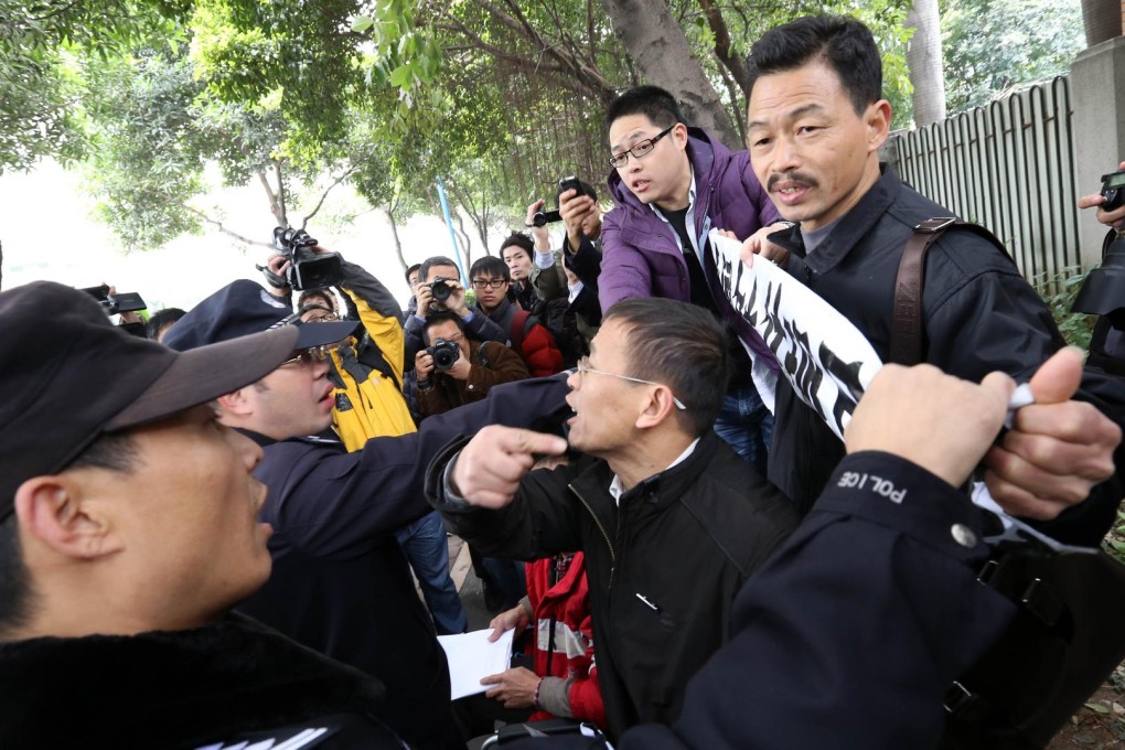 Police try to remove banners from protesters at the headquarters of Nanfang Media Group. Photo: AFP