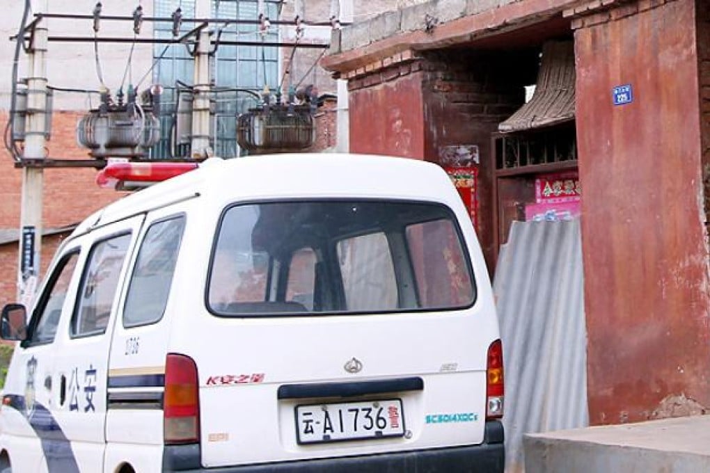 A police car parks in front of the suspected serial killer Zhang Yongming's home at Nanmen village, Yunnan province in May 2012. Photo: Simon Song