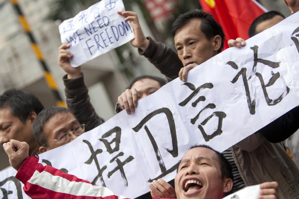 Rights advocates rally in front of the Southern Media Group headquarters in Guangzhou as the Southern Weekend row spreads to Beijing. Photo: NYT