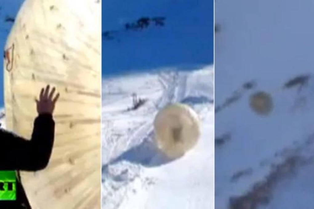 These video grabs show the "zorb", with two men inside, veer off course and sail over a precipice in the Caucasus Mountains. One man died and the other was badly injured.