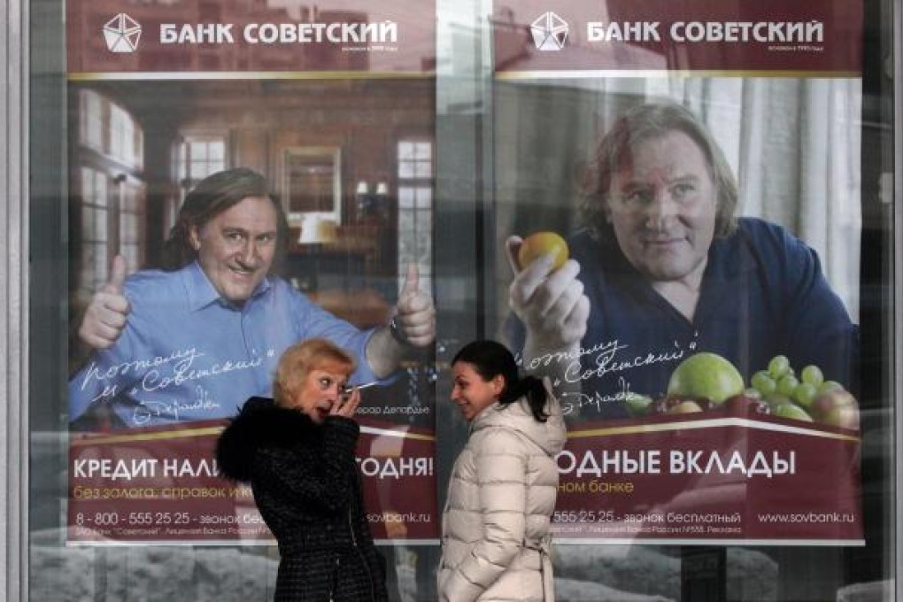 Posters of French actor Gerard Depardieu in a St Petersburg bank in Russia. Depardieu was granted Russian citizenship by President Putin. Photo: EPA