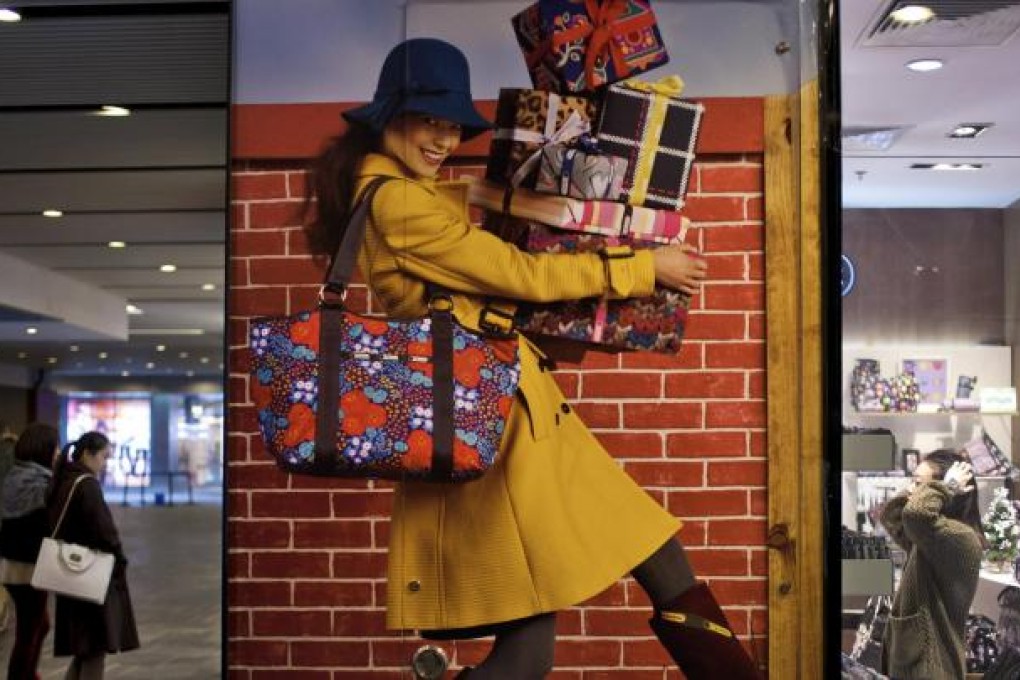 A display poster promoting fashion products at a shopping centre in Beijing. The mainland is moving towards a consumption-driven economy through urbanisation. Photo: AP