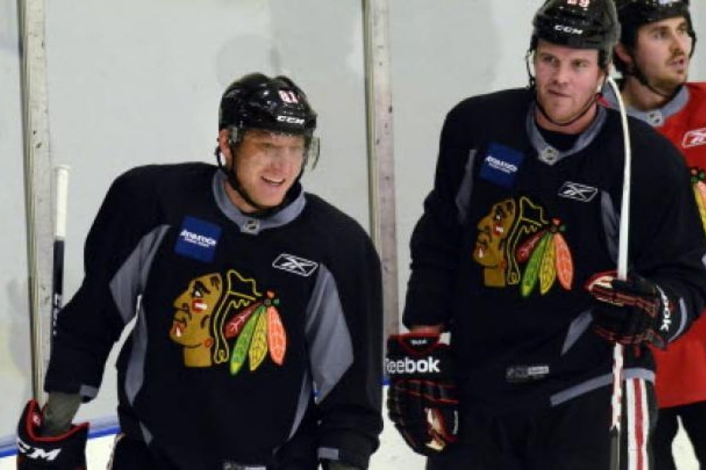 Chicago Blackhawks' Marian Hossa , left, smiles during an informal NHL hockey workout in Chicago. NHL players will vote on a new labour deal that could end a four-month lockout. Photo: AP