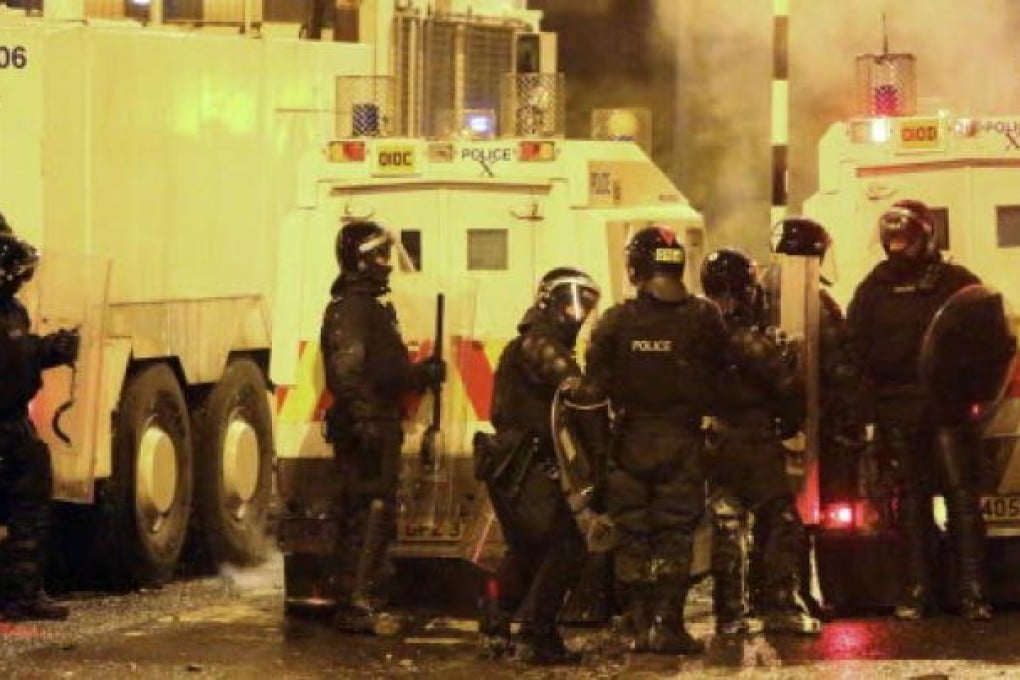 Northern Ireland riot police officers confront Pro-British Loyalists who were launching fireworks, petrol bombs and rocks at Newtownabbey in Northern Ireland. Photo AFP