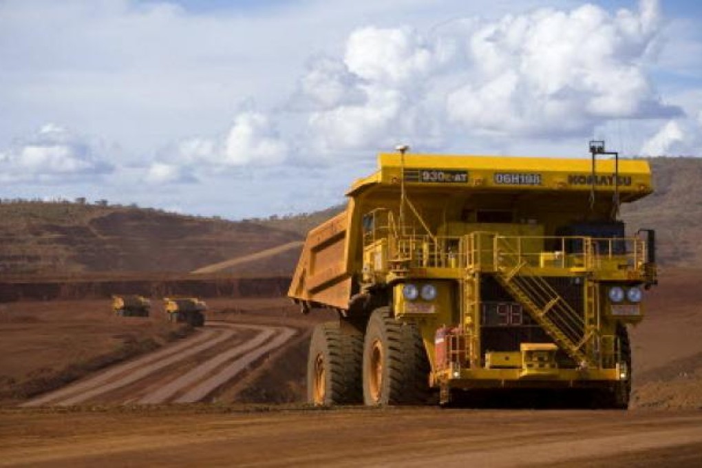 Tipper trucks operating at a Rio Tinto iron ore mine in Western Australia. Photo: Reuters