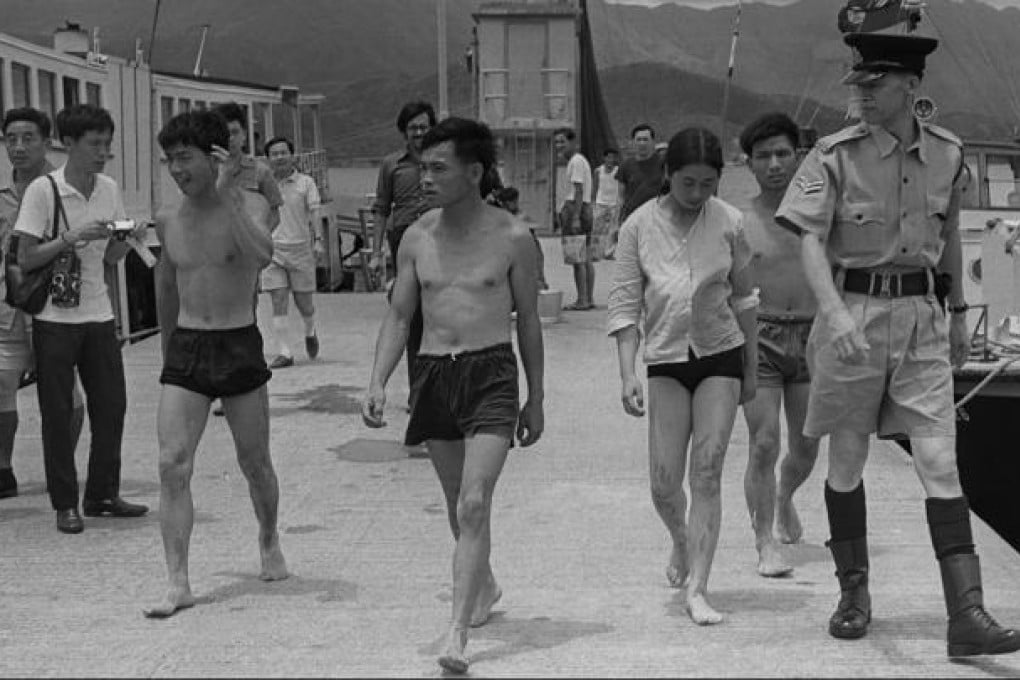 Four "freedom swimmers" are led away by police for questioning at Tai Po Kau in May 1971. The four were part of a mass exodus over more than 20 years. Photo: Chu Ming-hoi