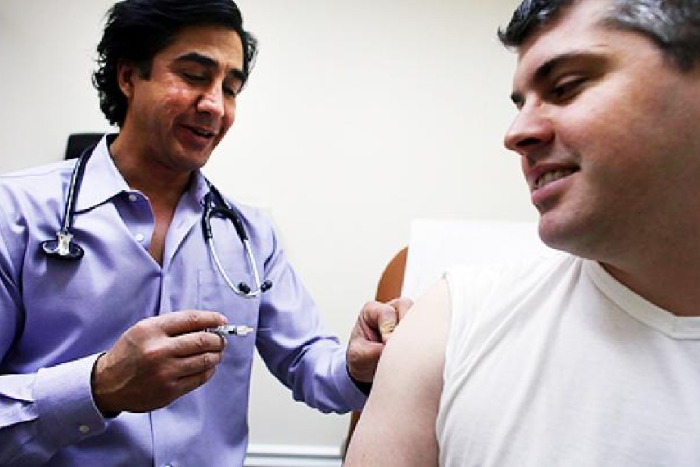 Aaron Lemma receives a flu shot by Dr Sassan Naderi at a health clinic in New York. Photo: AFP