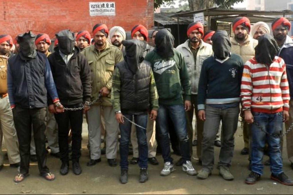 Indian police personnel present six arrested men, accused of a gang rape in Punjab state. Photo: AFP