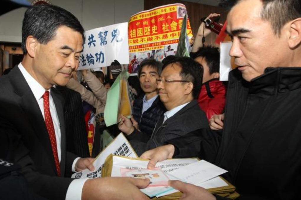 Chief Executive Leung Chun-ying receives petition letters from citizens at government headquarters. Photo: Edward Wong