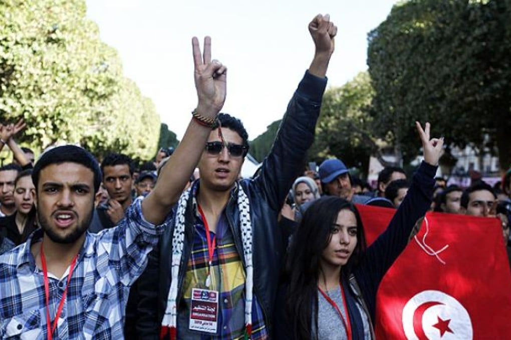 People attend a concert during celebrations of the second anniversary of the Tunisian revolution at Avenue Habib Bourguiba in Tunis, on Sunday. Photo: Reuters