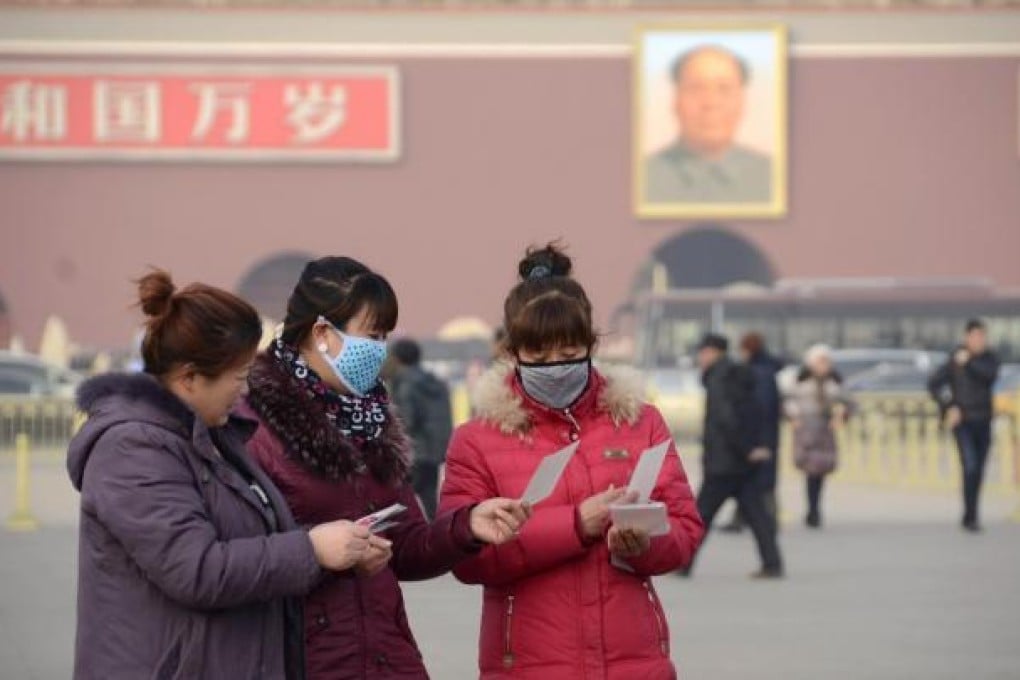 Women wearing face masks in Beijing's Tiananmen square.