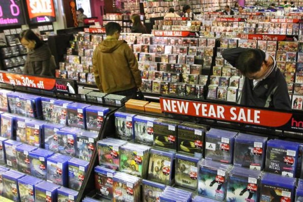 Customers browsing at the HMV store in Causeway Bay, with racks of DVDs on sale. Photo: Edward Wong