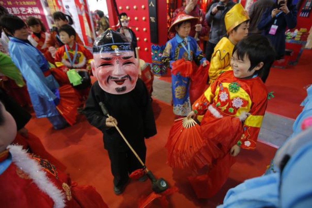 The shadow puppet troupe has 43 adult dwarf artists, who perform plays all year round at a shadow puppet cultural centre in Beijing. Photo: Reuters