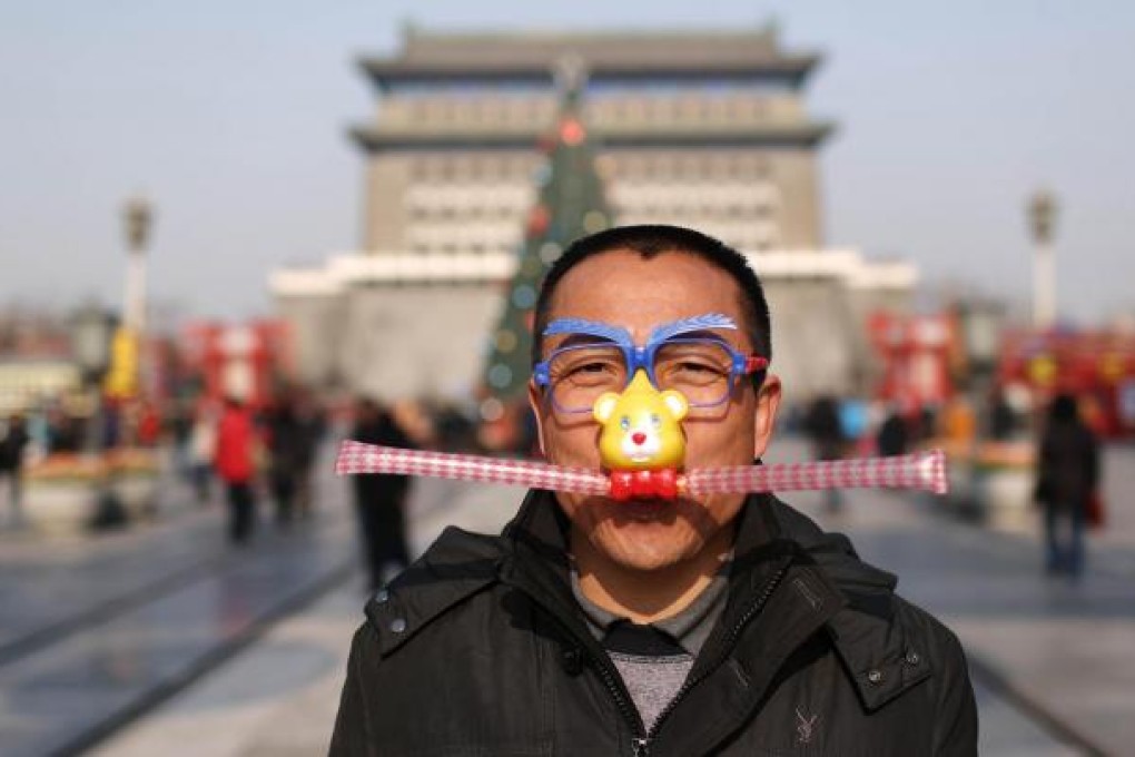 The brief return of sunshine in Beijing yesterday morning encouraged one man to wear a cartoon mask. Photo: Xinhua