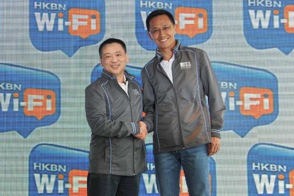 HKBN chief executive William Yeung (right) and Billy Yeung, founder and director of Y5Zone, seal their deal. Photo: SCMP