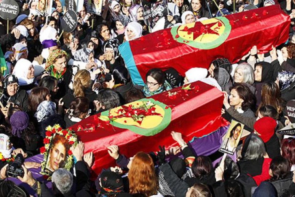 People carry the coffins of the Kurdish activists who were shot in Paris, during a funeral ceremony in Diyarbakir on Thursday. Photo: Reuters