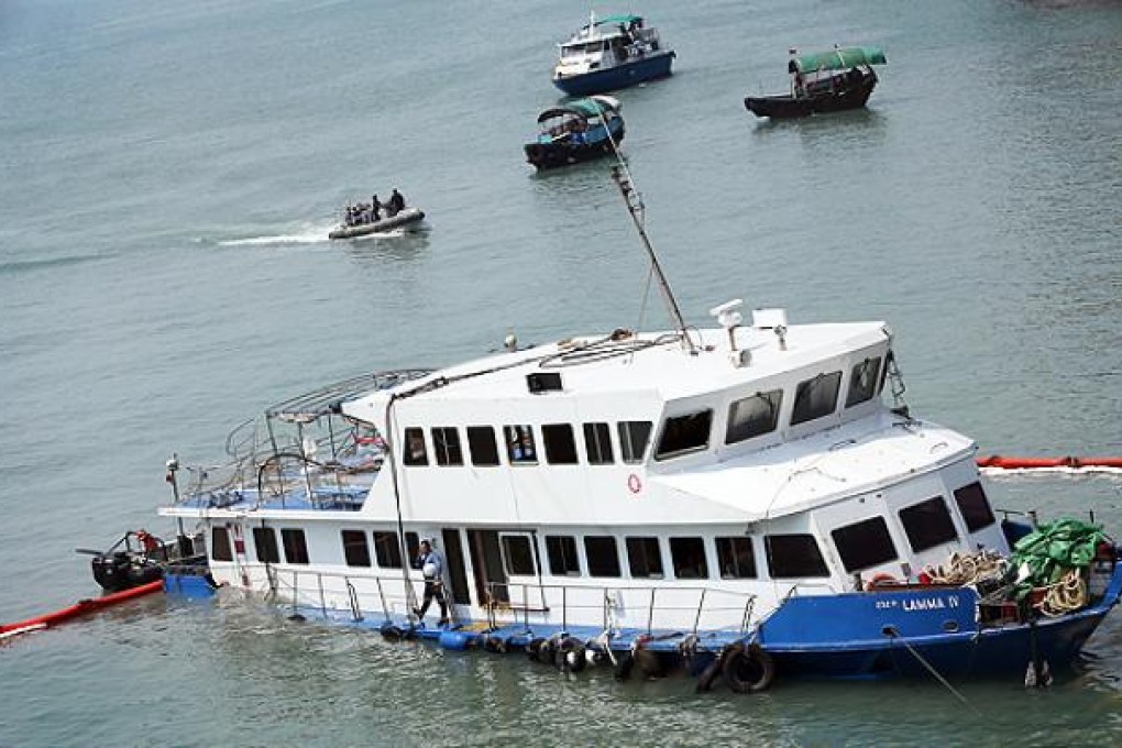 Fireman and police inspect the damaged Lamma IV. Photo: David Wong
