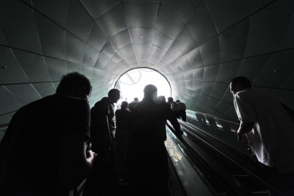 People take the escalator to a Singaporean casino. The race for an ever-higher rung on the social ladder has bred jealousy and stress among citizens, observers say. Photo: AFP