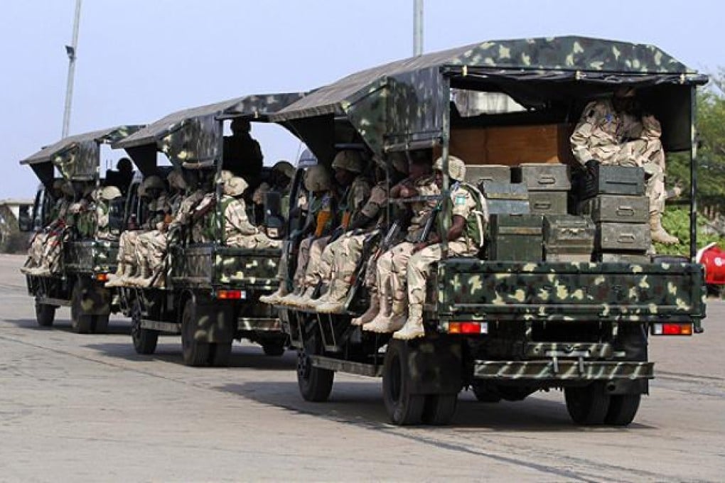 Nigerian soldiers sit in military trucks before leaving for Mali. Photo: Reuters
