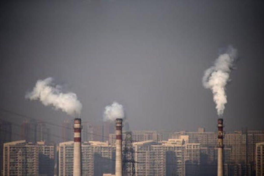 Smoking chimneys in front of residential buildings in Tianjin. The high level of pollution has prompted Li Keqiang to call for stricter enforcement of environmental protections. Photo: Reuters