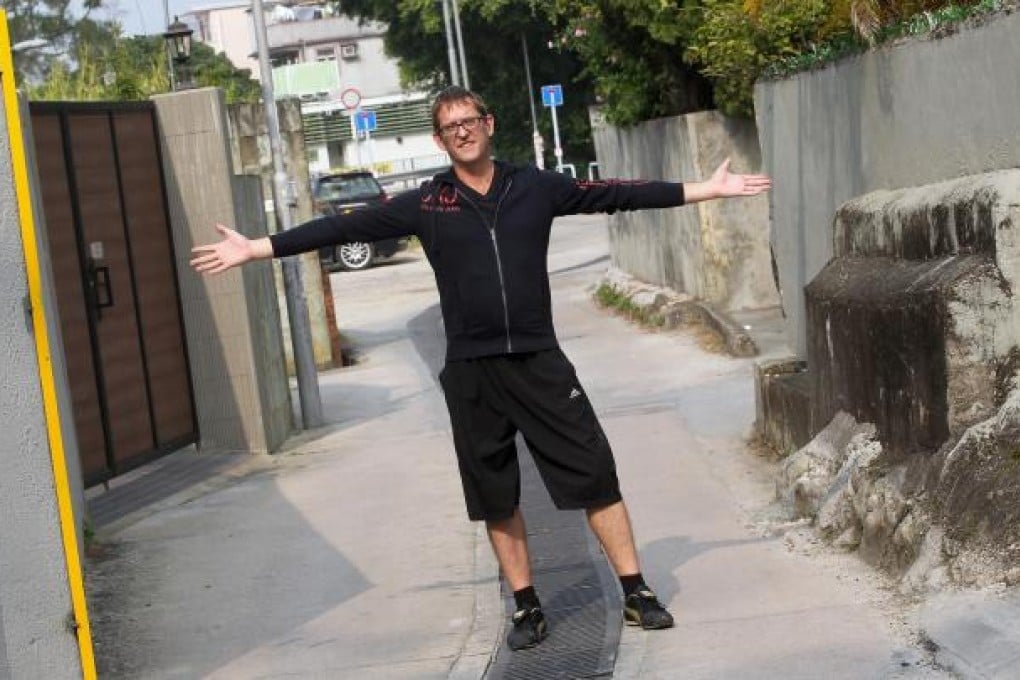Simon Watkiss shows how roads near his village home in Yuen Long are too narrow for most emergency vehicles. Photo: K.Y. Cheng