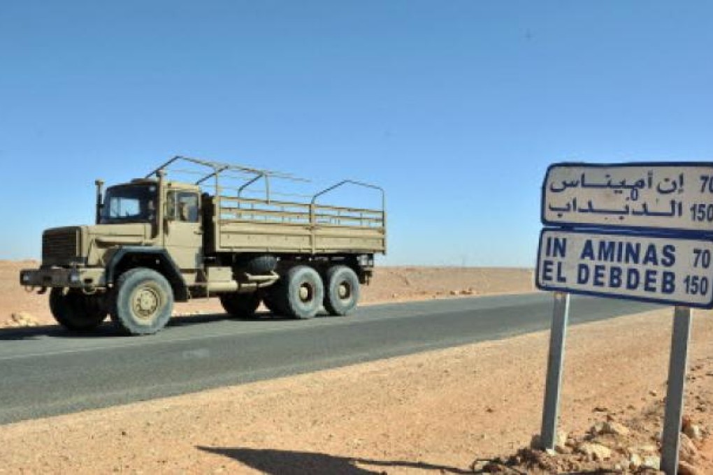 An Algerian military truck drives past a road sign indicating the city of Ain Amenas where hostages have been kidnapped by islamic militants at a gas plant. Photo: AP