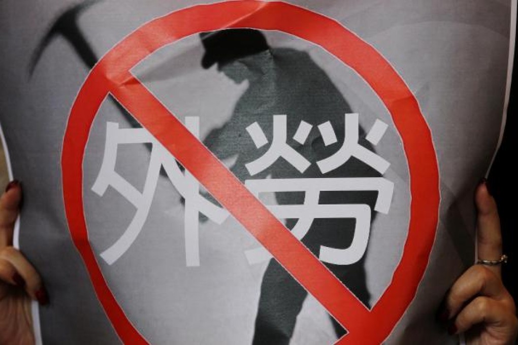 A protester's poster says no to foreign labour. Photo: K. Y. Cheng